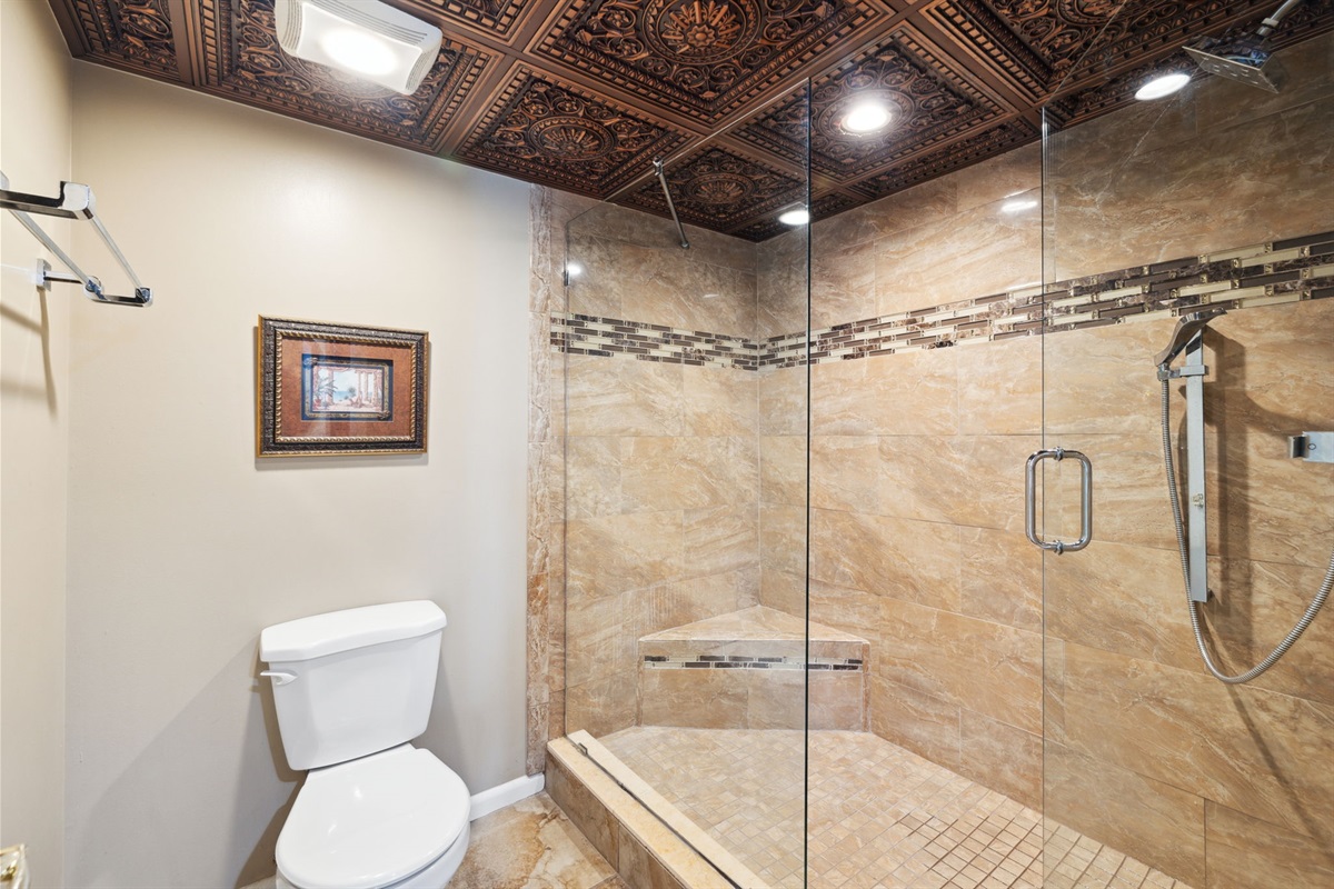 Walk-in shower in en-suite bathroom attached to master king suite bedroom