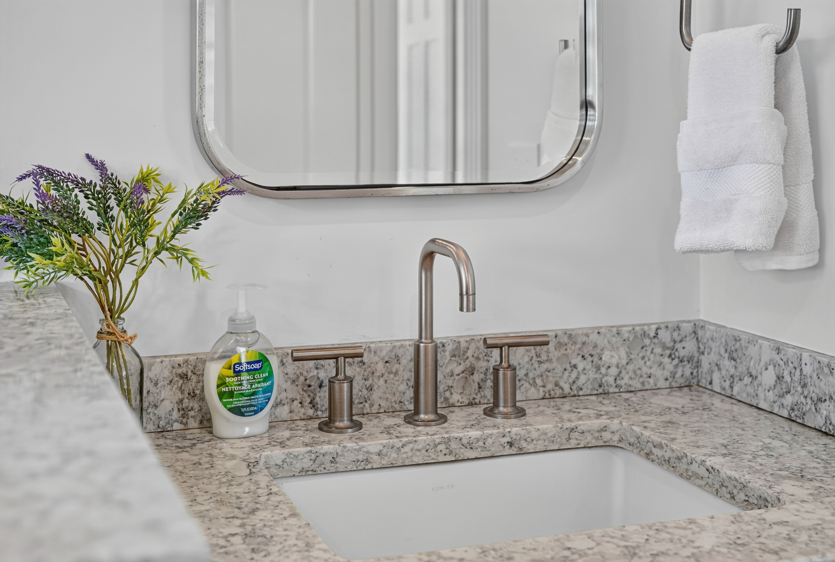 Granite vanity and sink offer a clean, convenient space for your daily routine.
