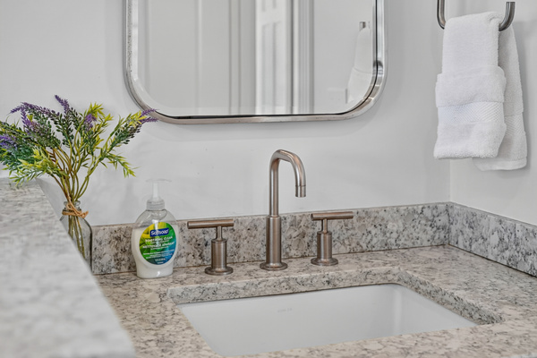 Granite vanity and sink offer a clean, convenient space for your daily routine.
