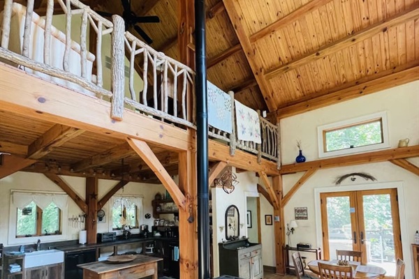 View of kitchen and dining from the comfy living room, complete with propane burning fire place