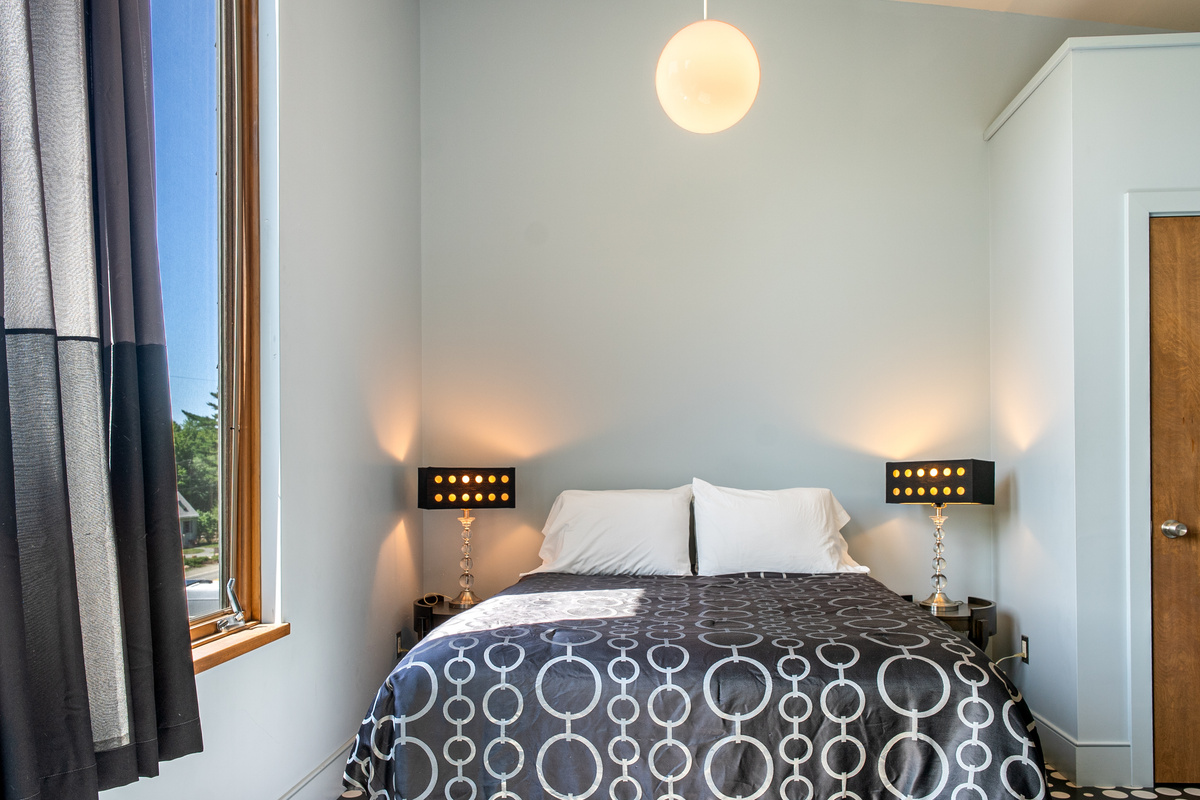 Sophisticated symmetry in the "Sky Loft" queen suite. From the designer lamps to the custom textiles, every detail has been chosen to create a modern, boutique-style retreat at the summit of The Crag.
