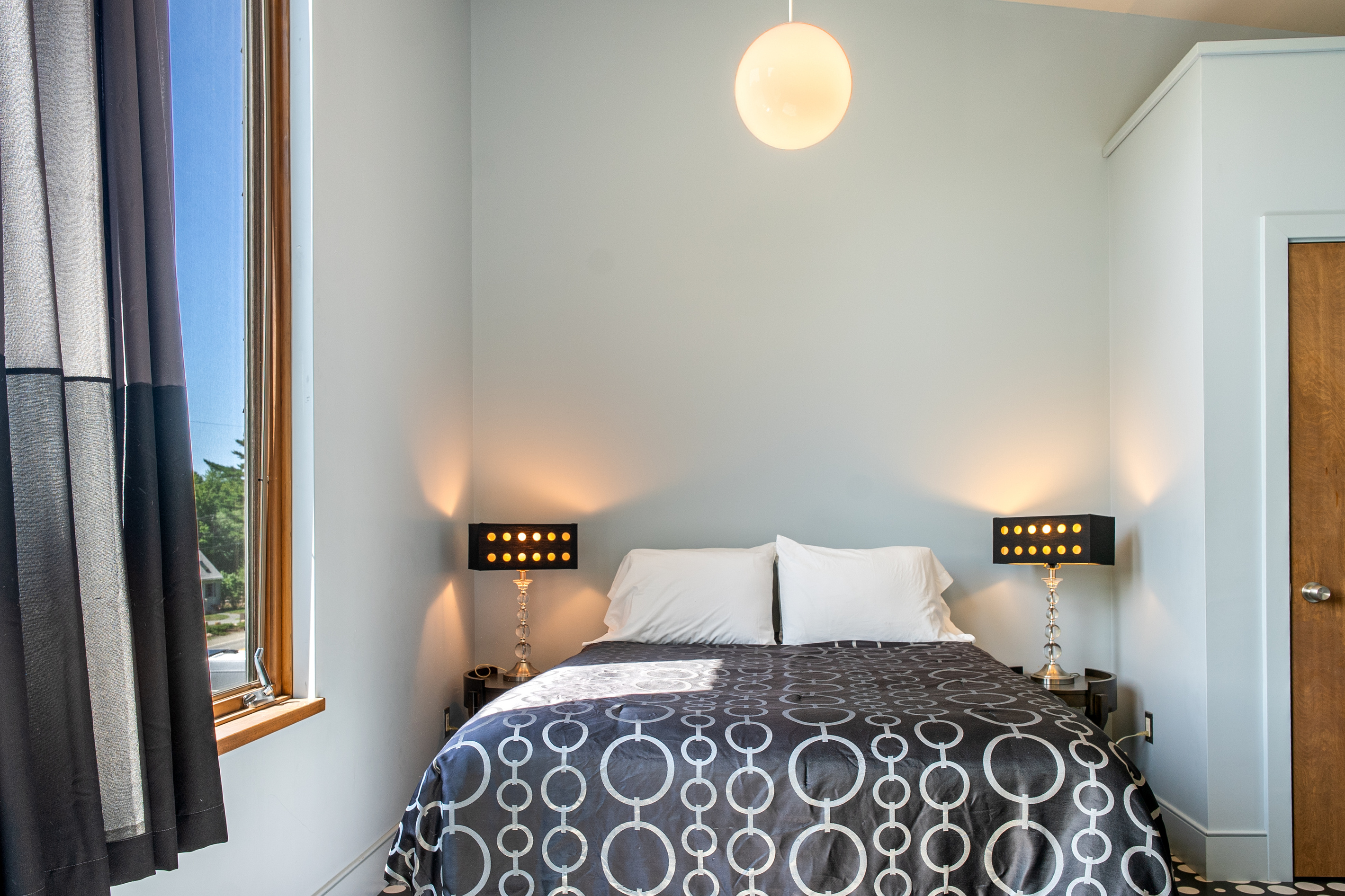 Sophisticated symmetry in the "Sky Loft" queen suite. From the designer lamps to the custom textiles, every detail has been chosen to create a modern, boutique-style retreat at the summit of The Crag.
