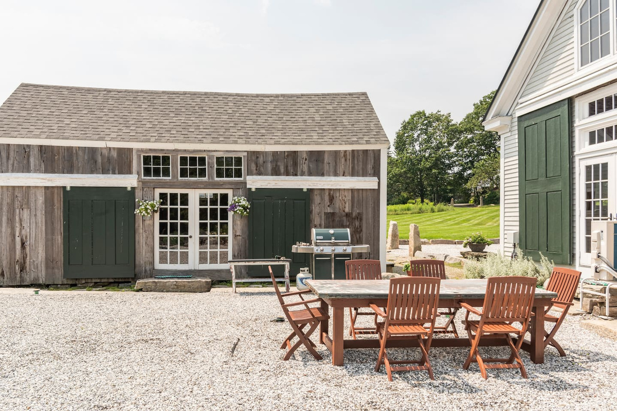 Outdoor patio with a dining table and a shared grill between Pennysworth and Sheepshed