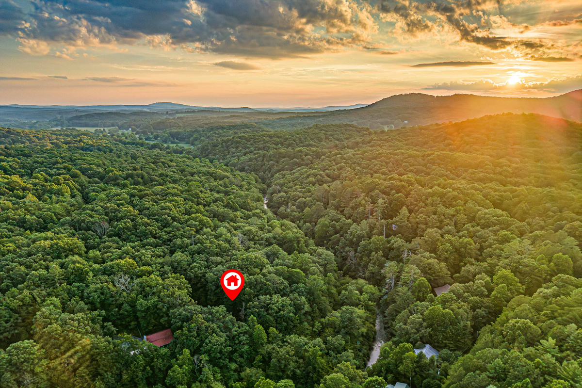 Nestled among the trees with the beautiful Cartecay River winding around the property.