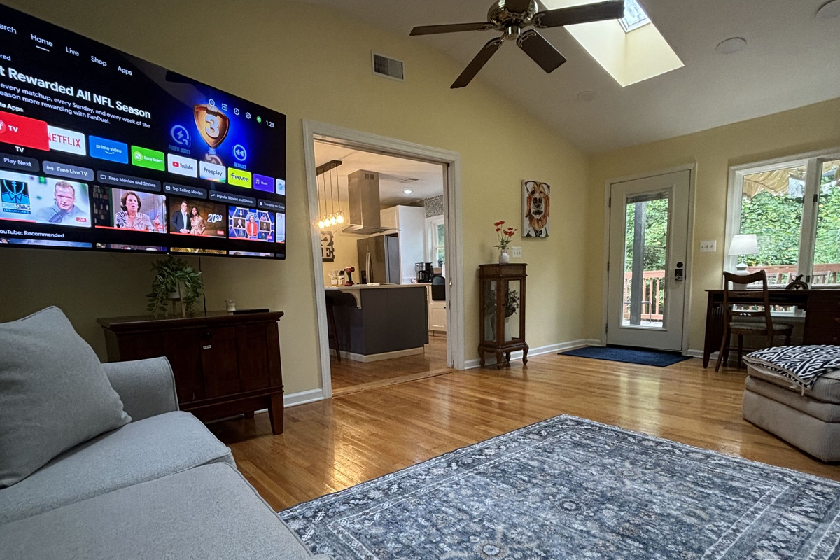 New Living Room: Relax in this bright, open space featuring cozy seating, beautiful views of nature, and a Smart TV.