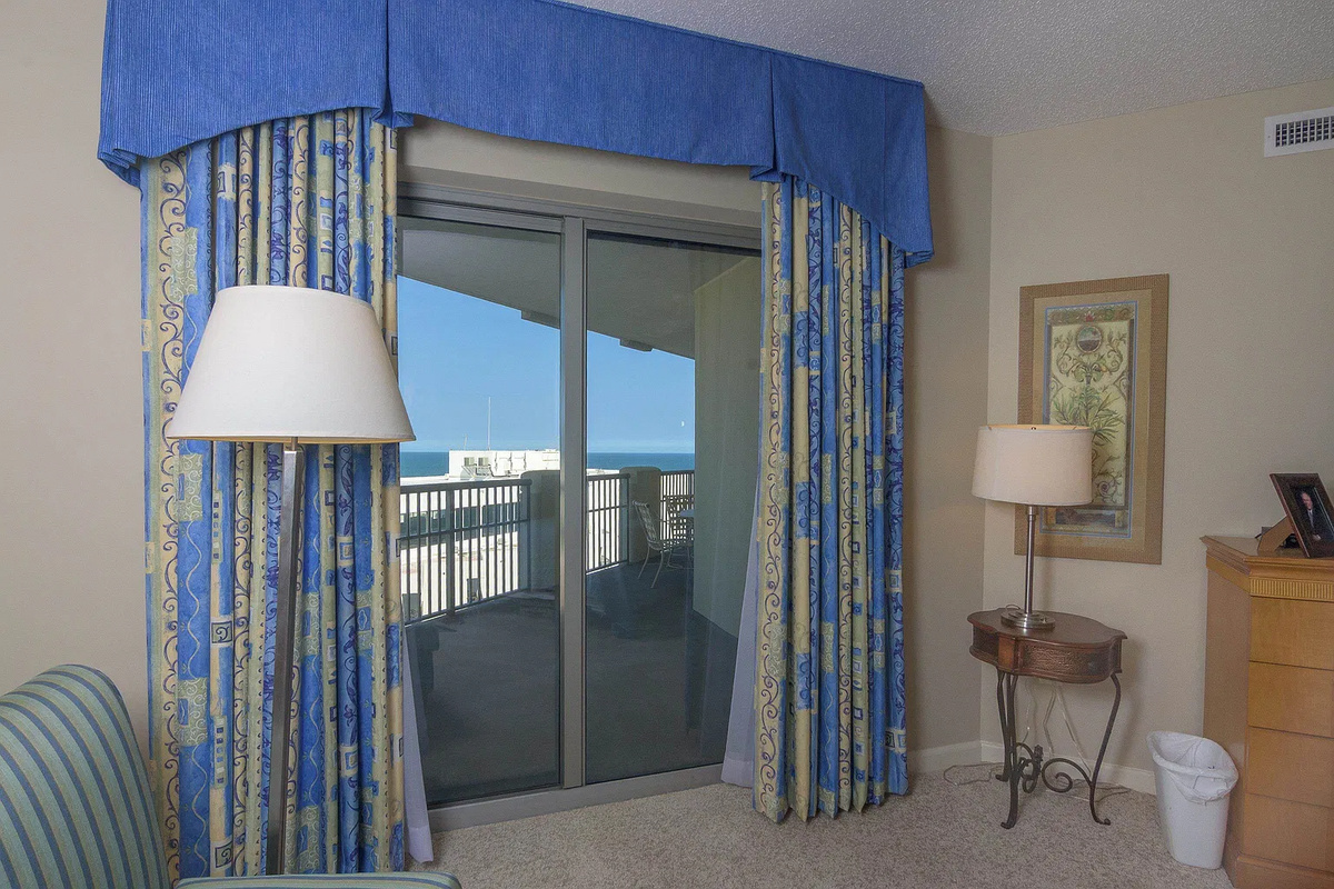 Spacious main bedroom with king bed, balcony access and ensuite