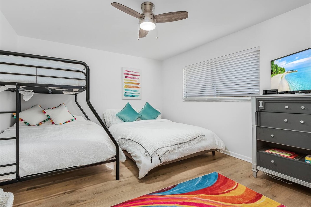 Perfect for families, the 2nd Guest bedroom includes a bunk bed, a queen-sized bed, and a TV for everyone's comfort and fun.