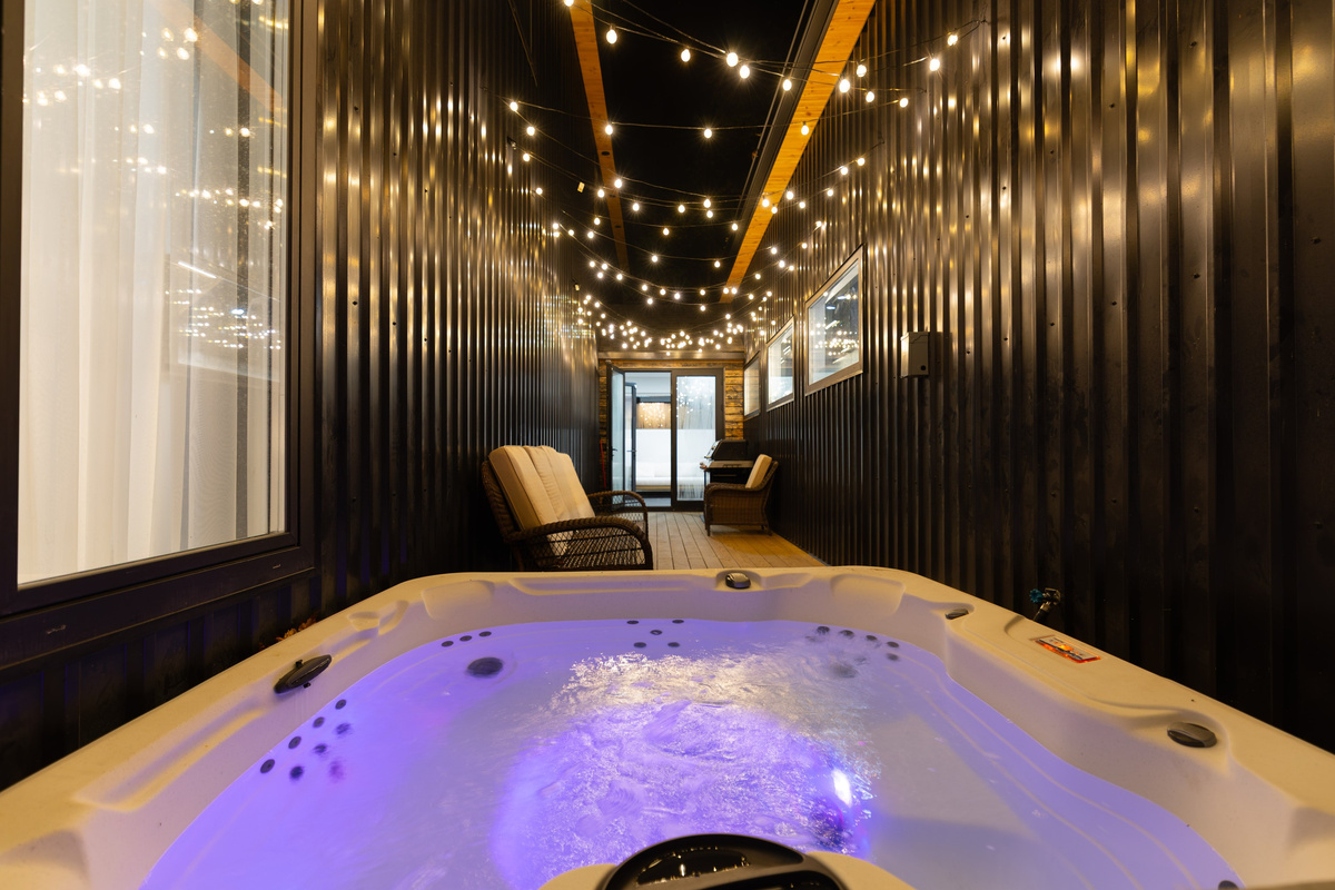 Soak in the bubbling hot tub under a canopy of string lights, starlit in any season