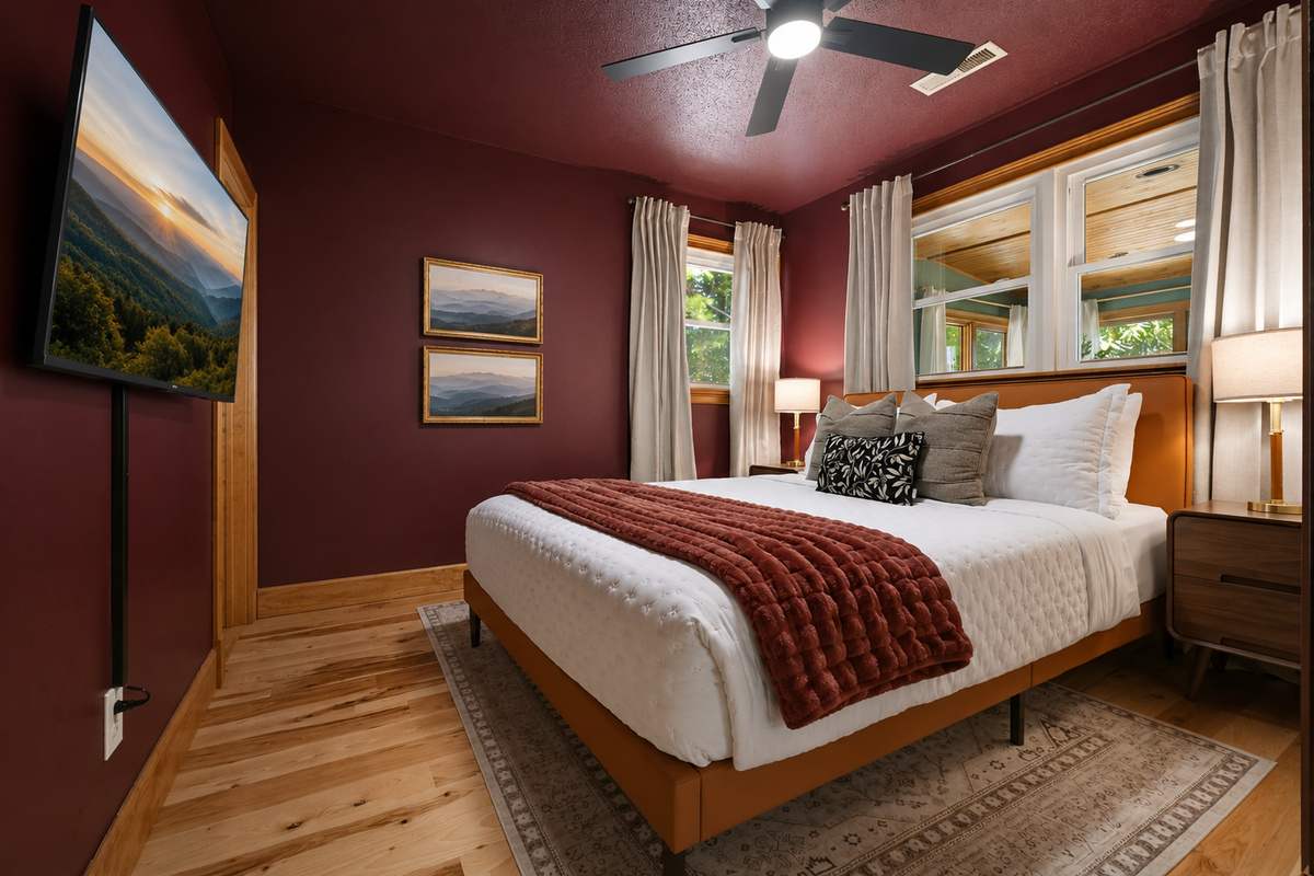 {Bedroom 2} Wrapped in warm tones with peaceful woodland views, this inviting Queen Ensuite offers a quiet place to relax and recharge between adventures.