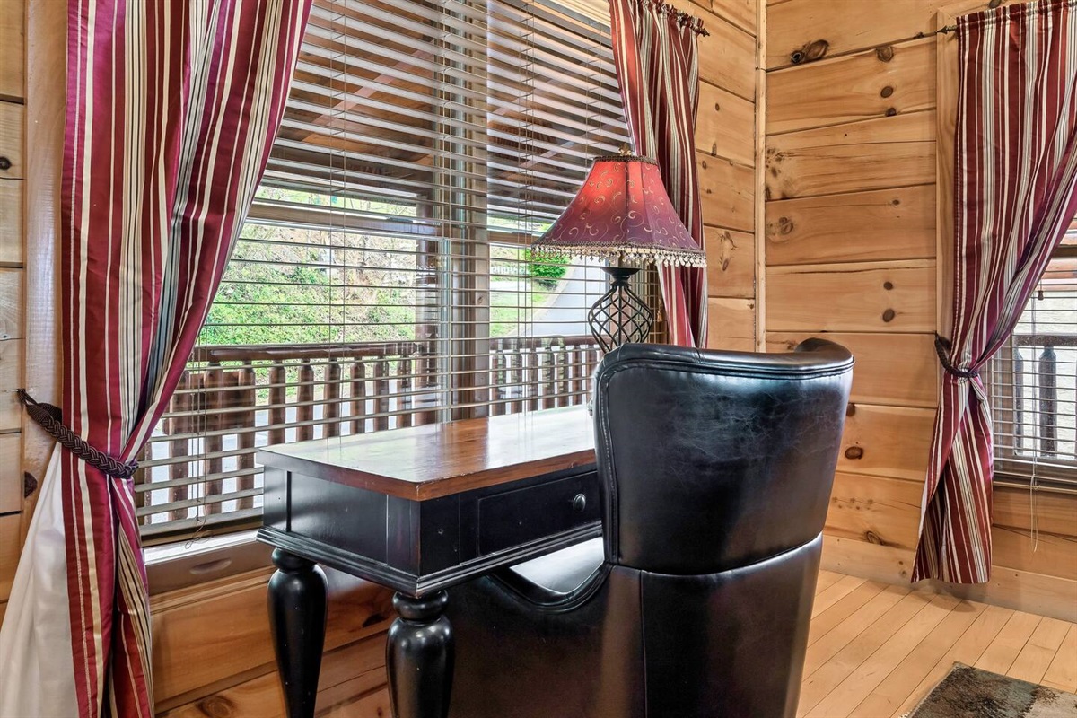 Small desk/work area located near the front door in the living room area.