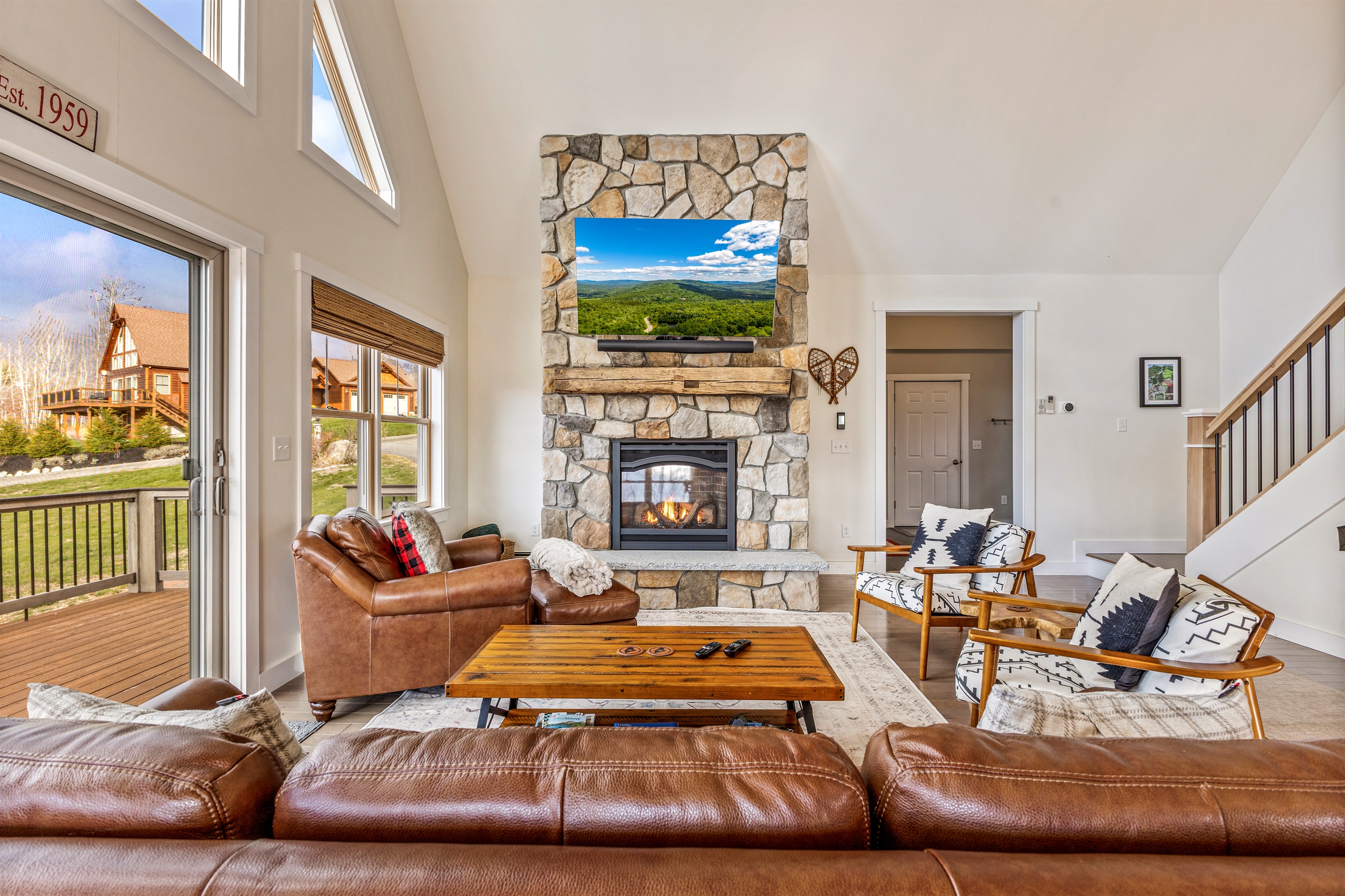 Open-concept main floor with plenty of space, mountain views, and a warm fireplace.