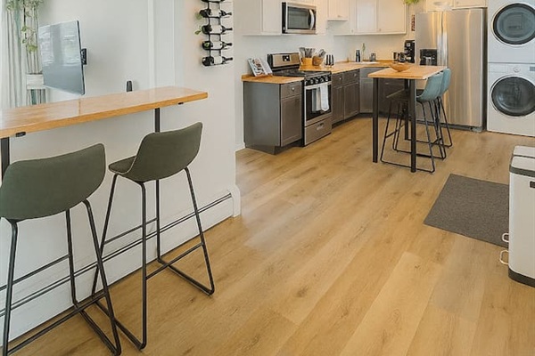 Dining area, fully equipped kitchen, and washer and dryer in unit.