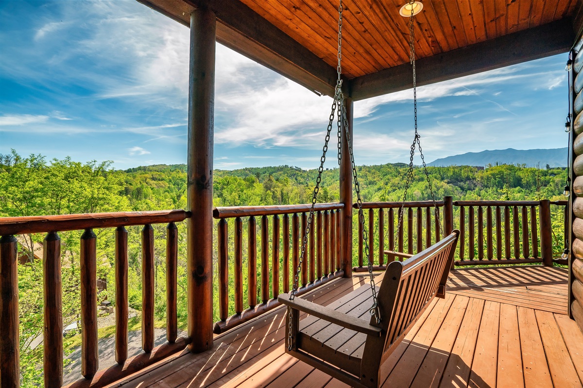 Expansive Deck Overlooking Mt. LeConte & Smoky Mountains National Park. This portion is covered witha swinging bench seat