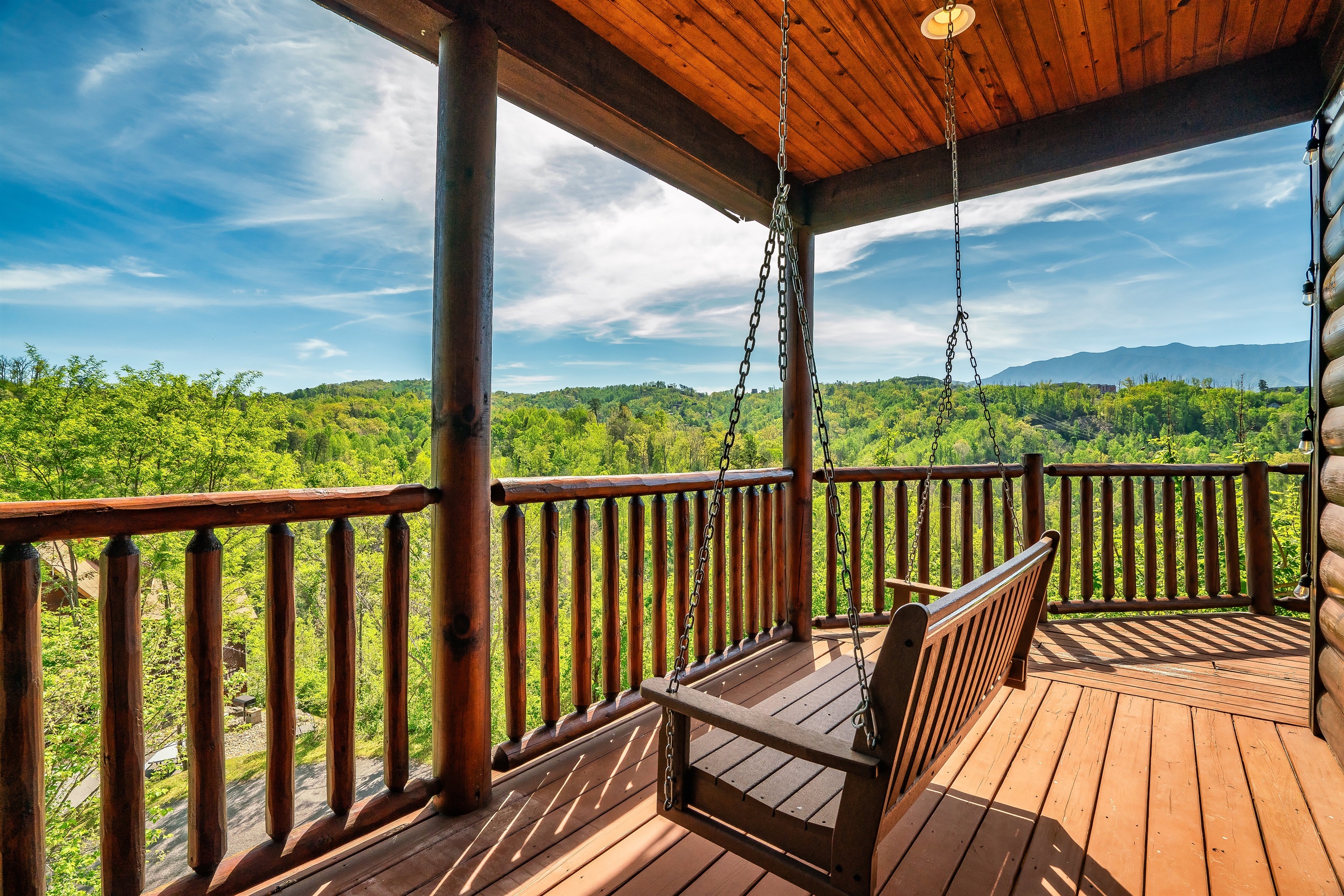 Expansive Deck Overlooking Mt. LeConte & Smoky Mountains National Park. This portion is covered witha swinging bench seat