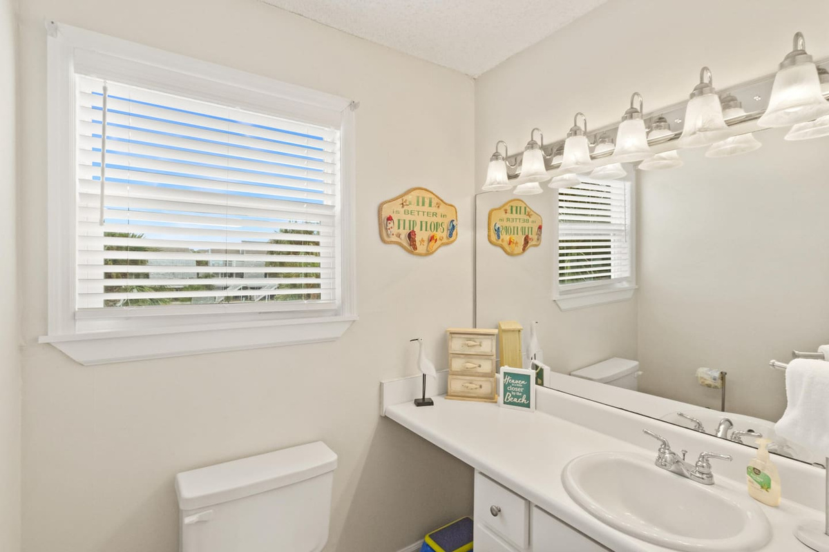 Use the main-level half bath between beach runs &mdash; it's clean, bright, and exactly where you'd want it.