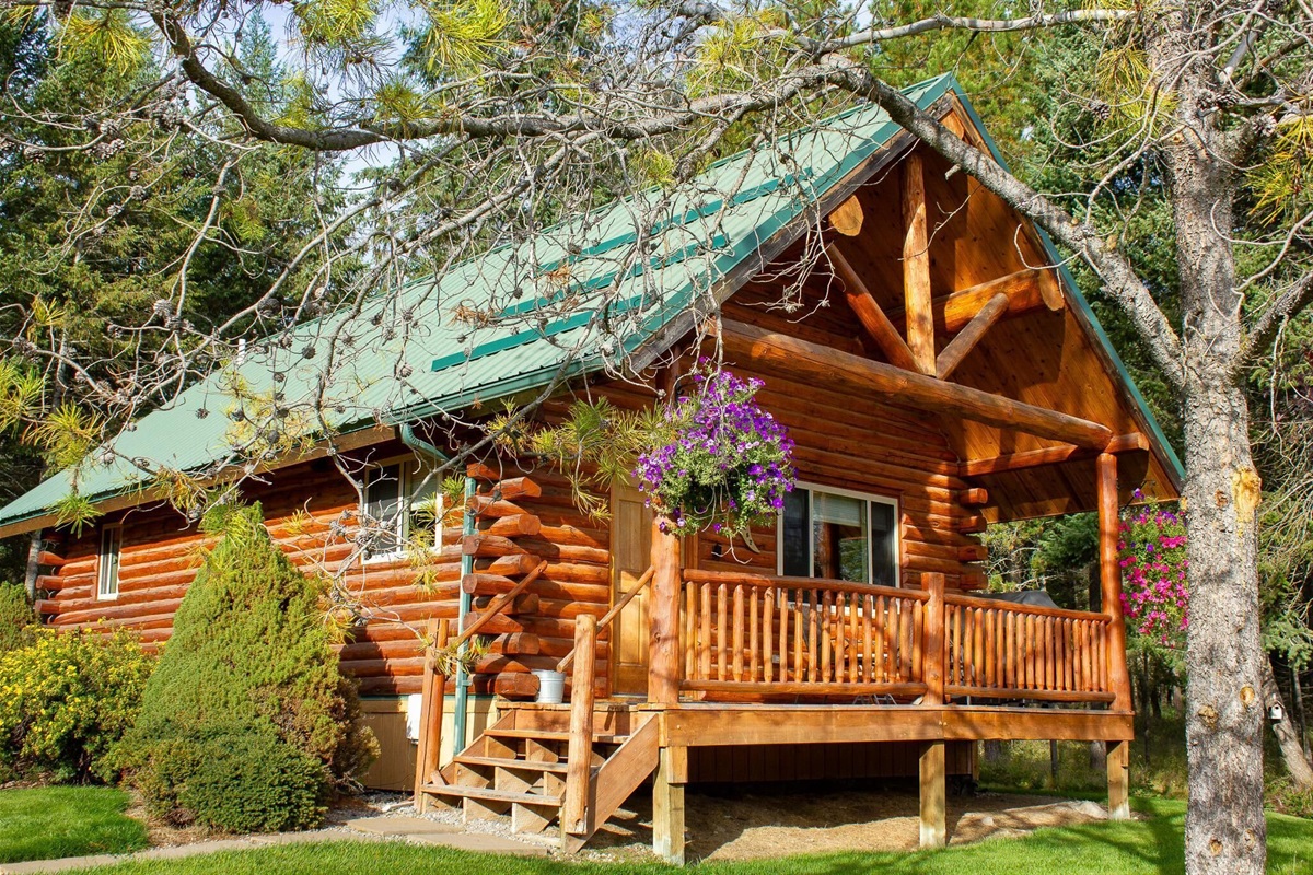Front of cabin with private deck, bbq, and views of the pond