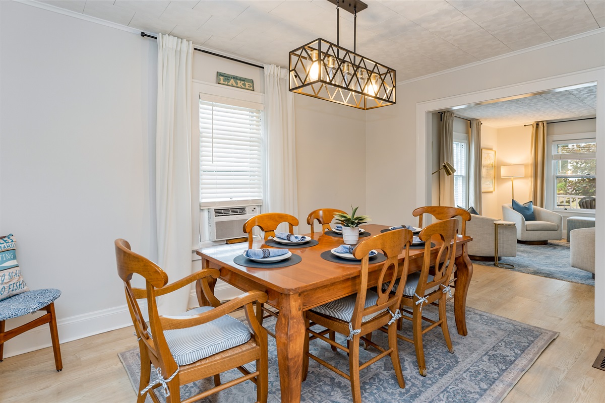 Open-concept dining area seamlessly connects to the cozy living space, ideal for both intimate dinners and lively group gatherings.