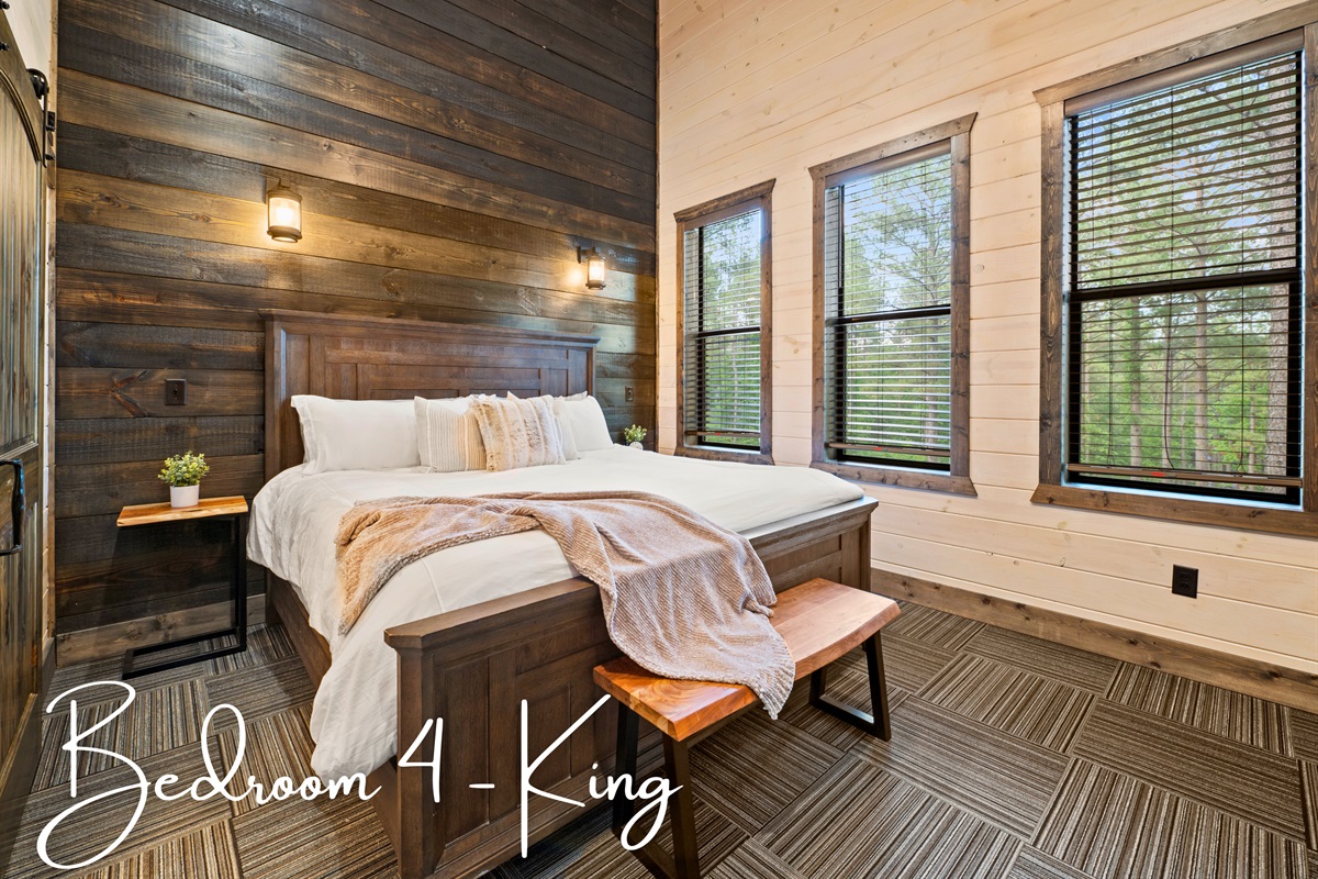 This bedroom features a comfortable king-sized bed and leather benches, offering a tranquil space for rest.