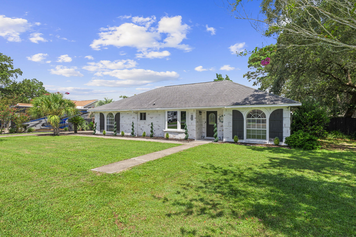 Curb appeal at its finest: classic arched shutters, a bay window, and a welcoming front door set the tone for your stay