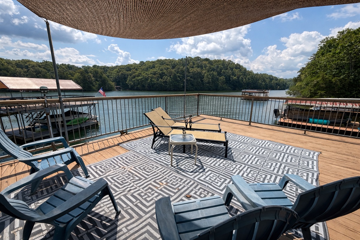 Relax on the private lakefront deck with lounge chairs, Adirondack seating, and peaceful Lake Lanier views.