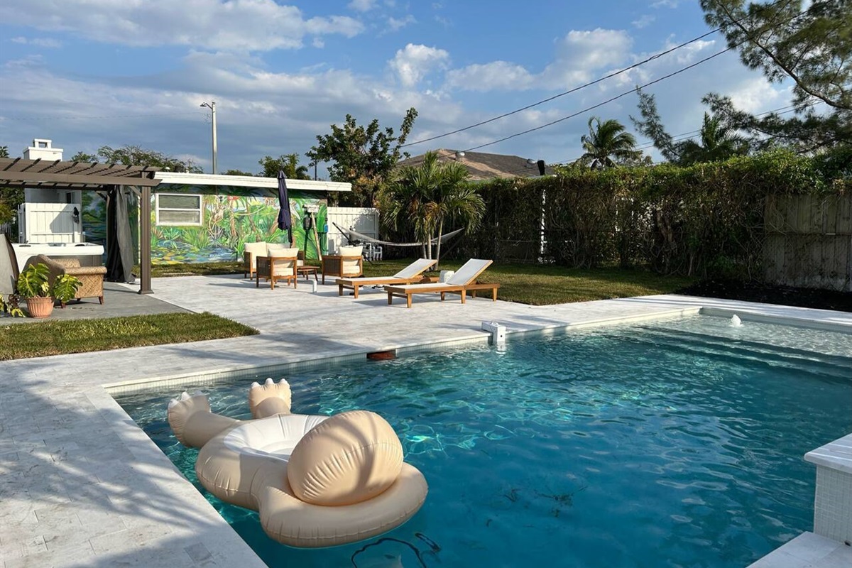 Completed in 2023, our oversized luxury pool comes with fountains, a waterfall and a unique, custom tropical mural on the back of the house. Enjoy this sliver of backyard paradise!
