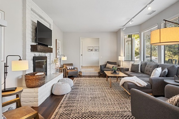 Sunken living room with double sided gas fireplace.