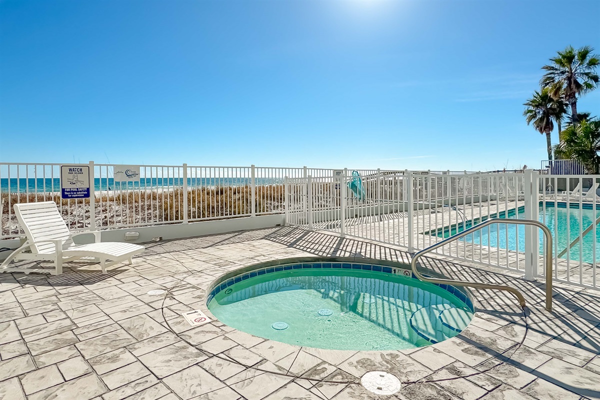 This charming outdoor space features a soothing hot tub and easy access to the pool, creating an ideal vacation retreat.