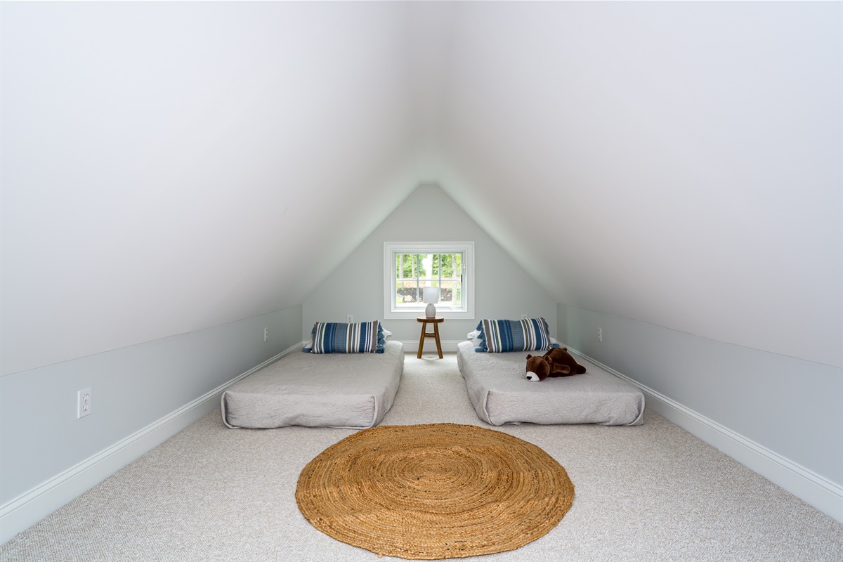 With a queen and two twin beds, this bedroom  offers space and flexibility for guests of all ages.