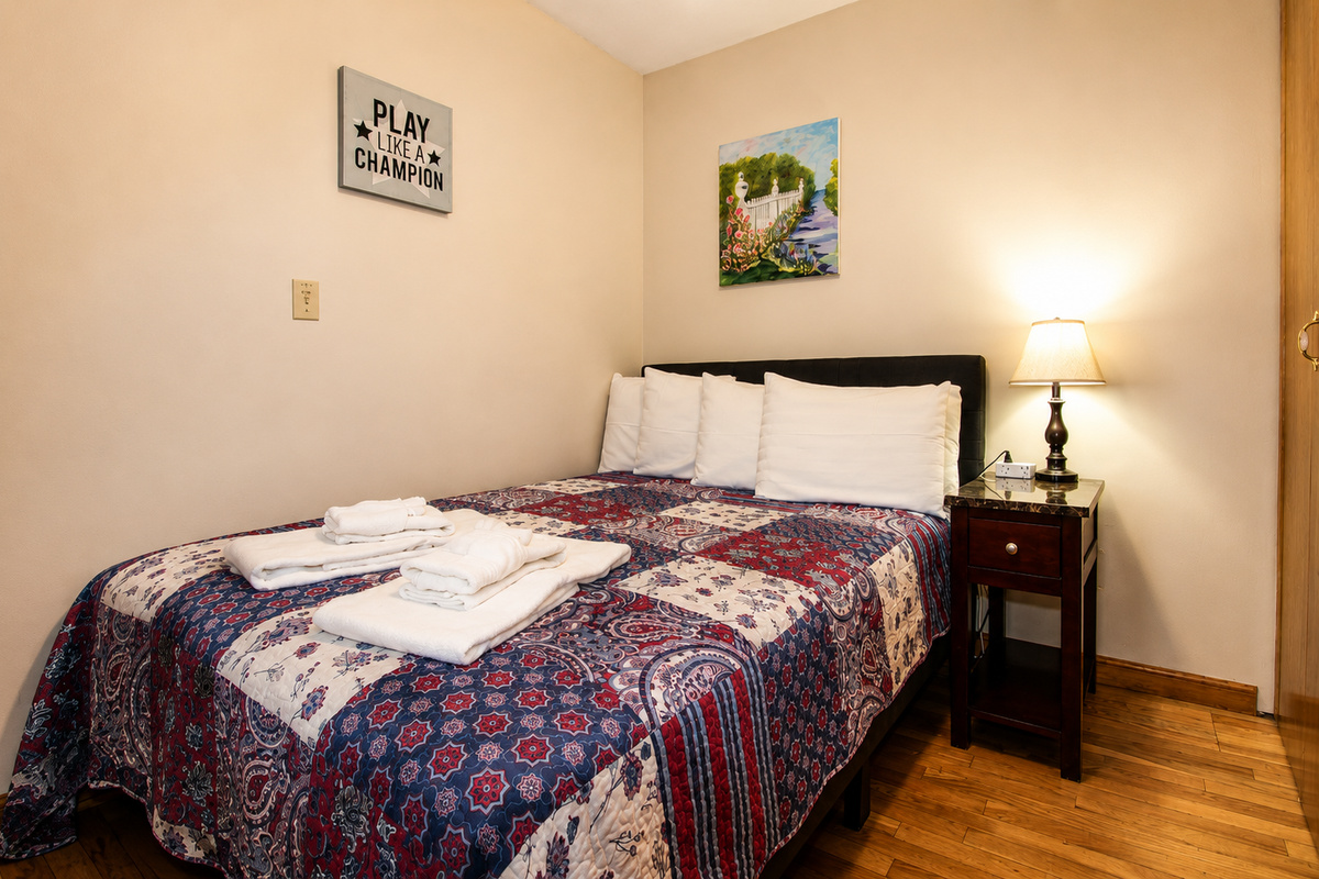 Bedroom #4 with a full bed, located on the first floor off the living room.