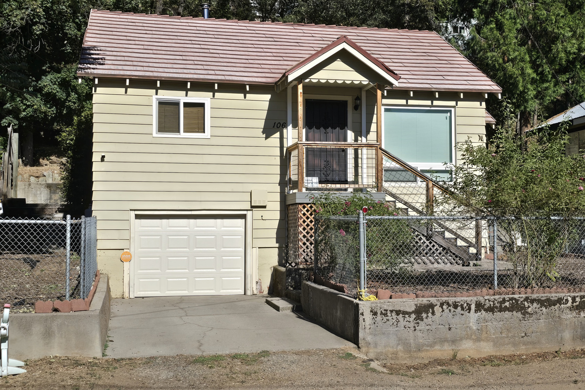 Driveway and single car garage. 