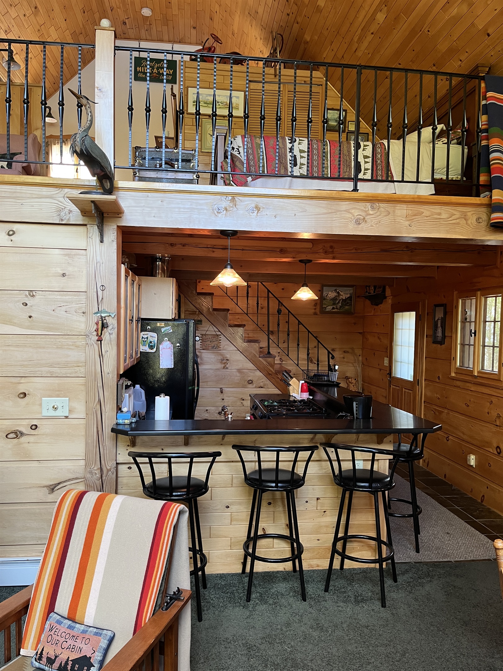 Kitchen area with sleeping loft above
