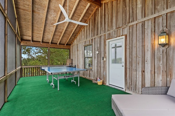 Front screened porch with ping pong table and outdoor lounge couch