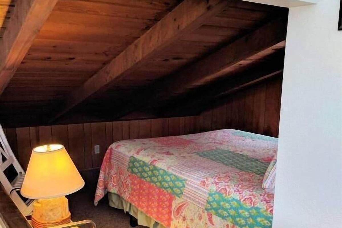 queen bed in open loft