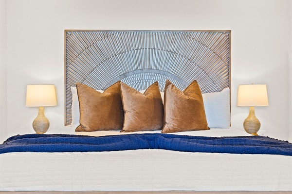 A haven of tranquility, this king-sized sanctuary is accented with a striking headboard and plush accents for dreamy relaxation.