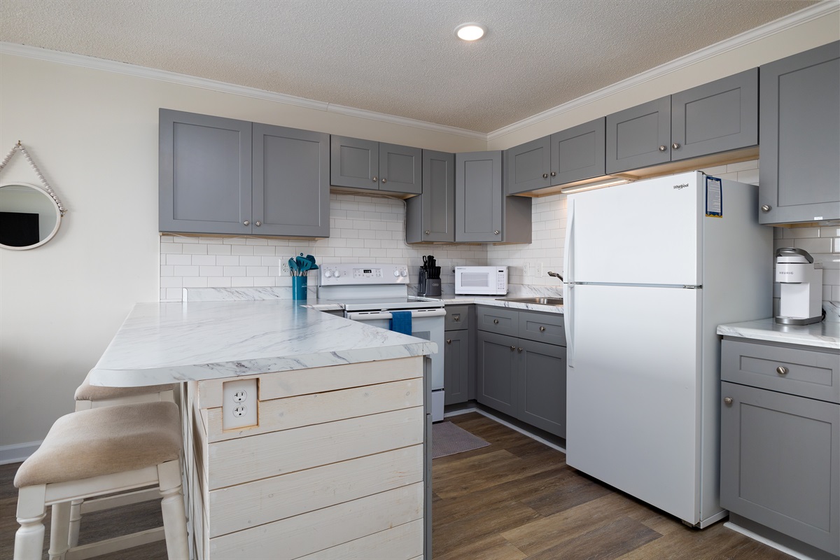 Spacious kitchen with bartop seating