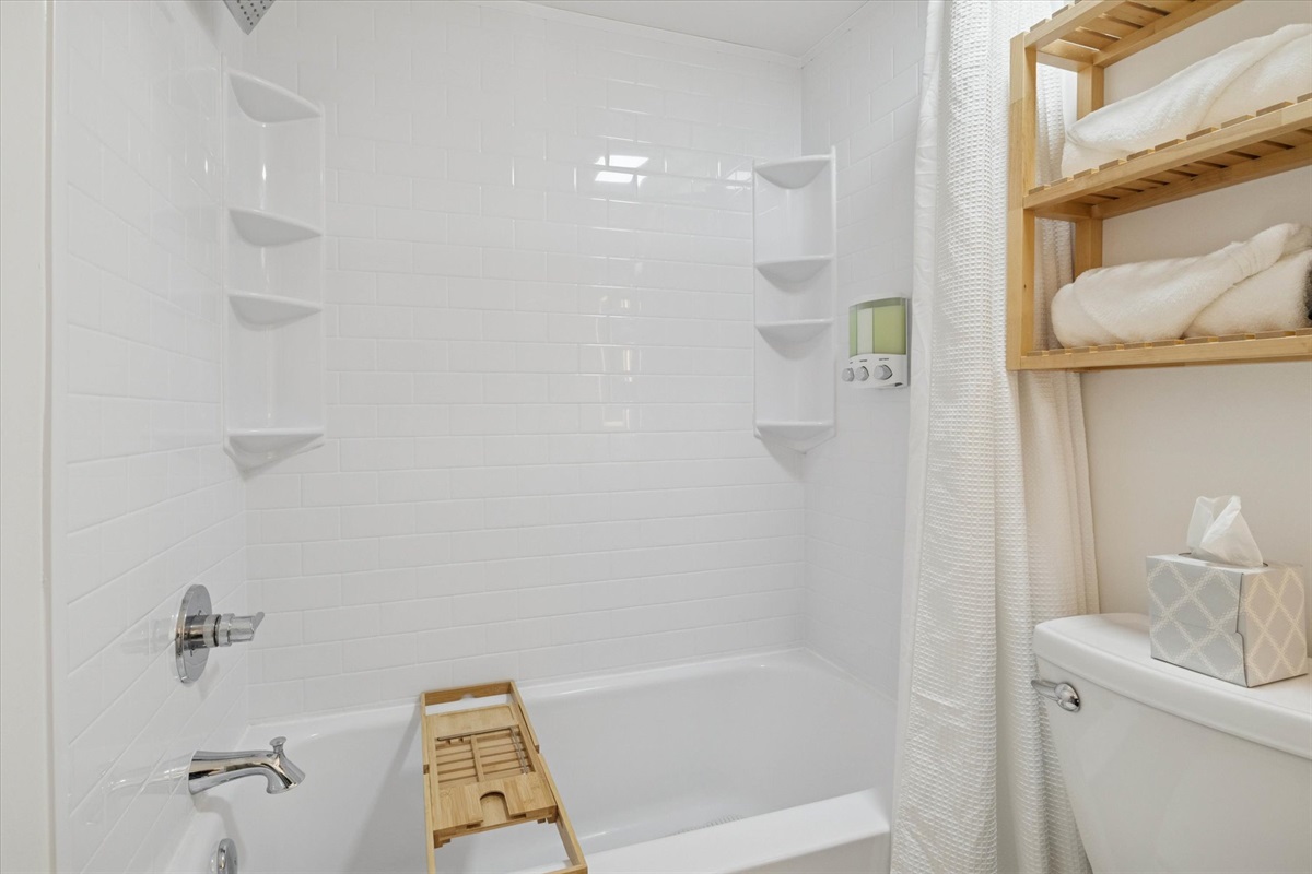Spa vibes, stocked and serene—our South Bend guest retreat features a tub with shampoo, conditioner, body wash, rolled towels, LED lighting, and a luxe bath tray for your book and beverage.