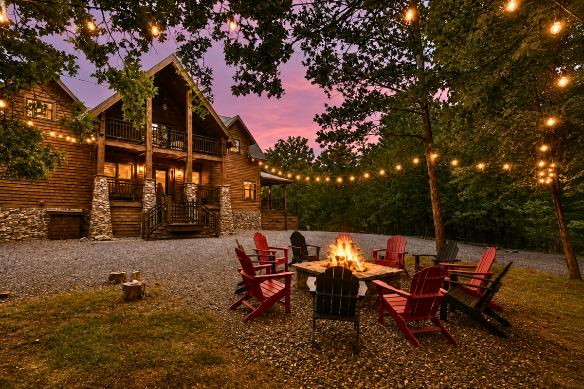 Evenings are made for gathering around the fire pit beneath the string lights, with plenty of seating for everyone to relax and enjoy the wooded surroundings.
