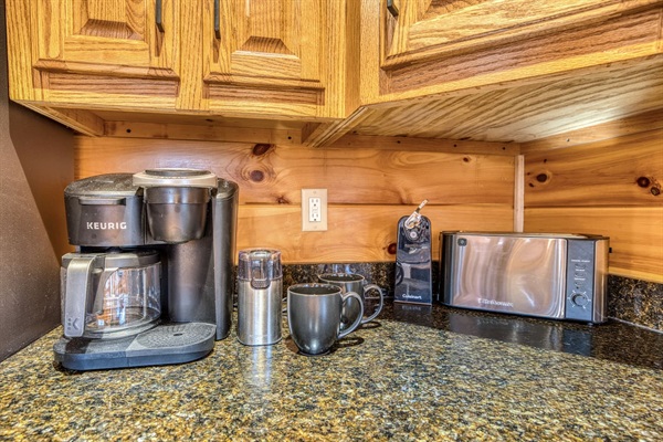 Coffee bar area in the kitchen with Keurig and drip coffee pot options. Fully stocked kitchen with low tox features like reverse osmosis water filter under the kitchen sink and attached to the fridge water, stainless steel pots and pans, glass and ceramic 