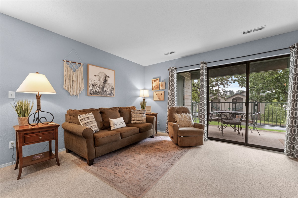 Natural light and patio views keep the living room feeling open and inviting.
