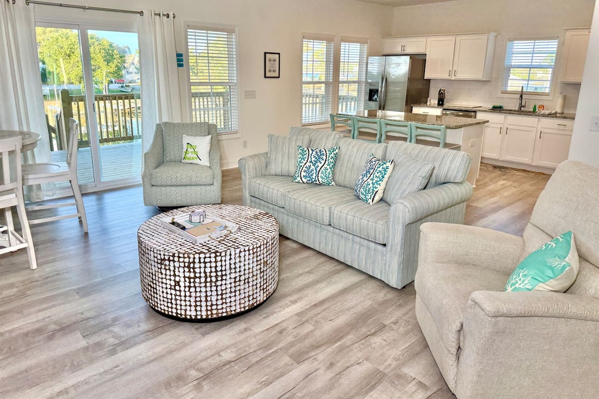 Get cozy while you relax in this living room with a fireplace and water view. Sofa bed features a Queen mattress. 