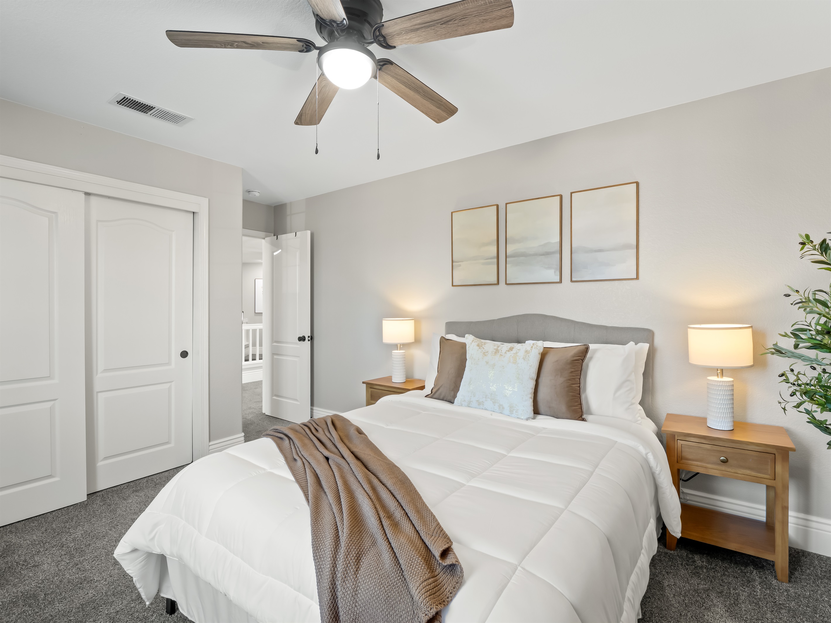 Comfortable and inviting bedroom with plush carpeting, cozy bedding, and ample closet space—perfect for a restful stay for the whole family.
