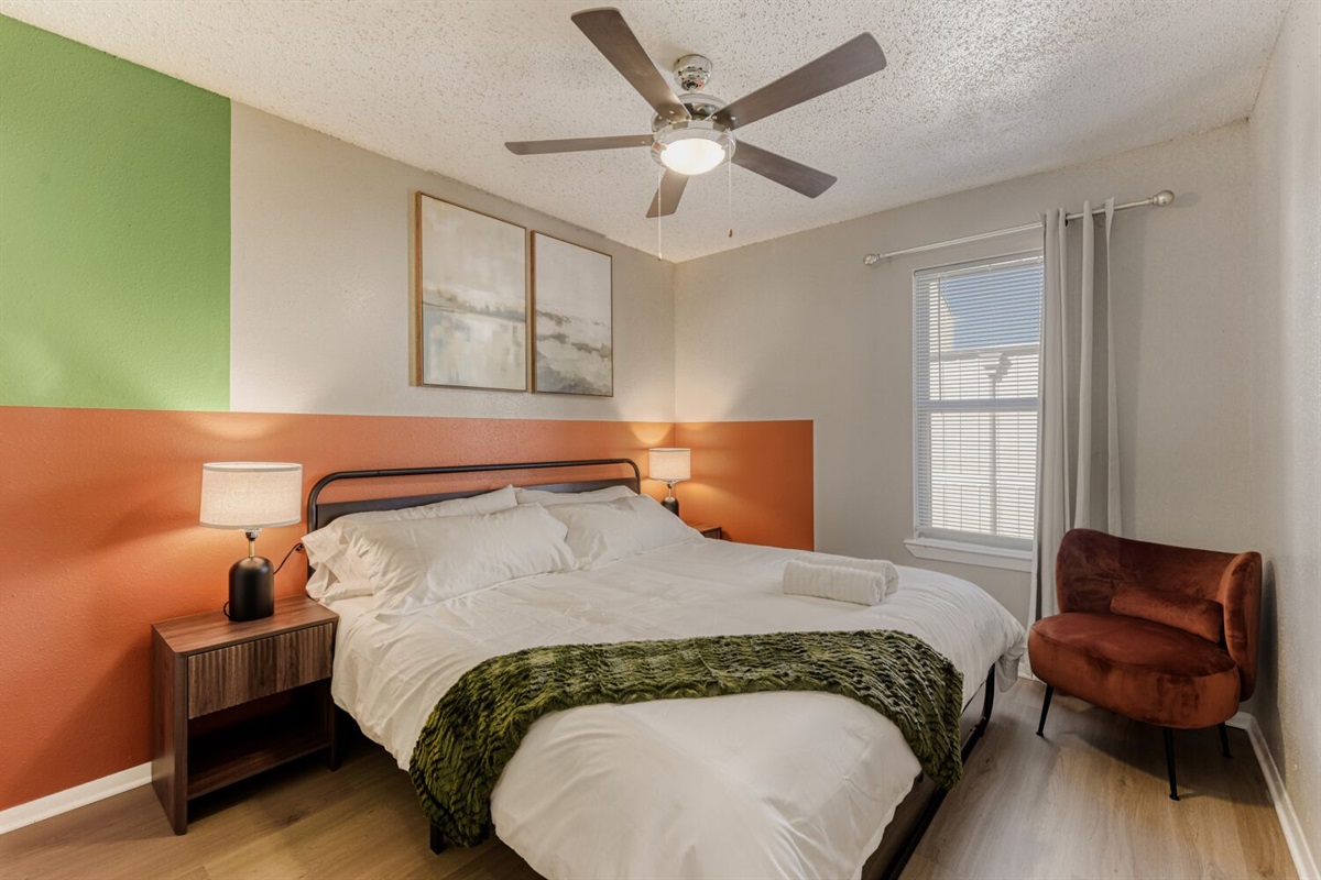 Cozy bedroom with warm tones, modern decor, and a relaxing atmosphere.