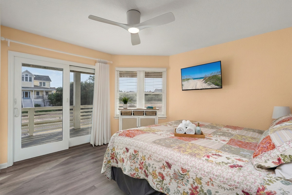 Wake up to breathtaking views in this bright and airy bedroom with balcony access.