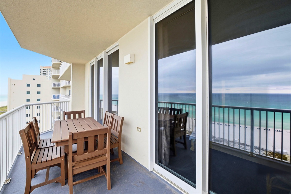 Sip your morning coffee or unwind after dinner while taking in the ocean breeze from this cozy balcony seating area.