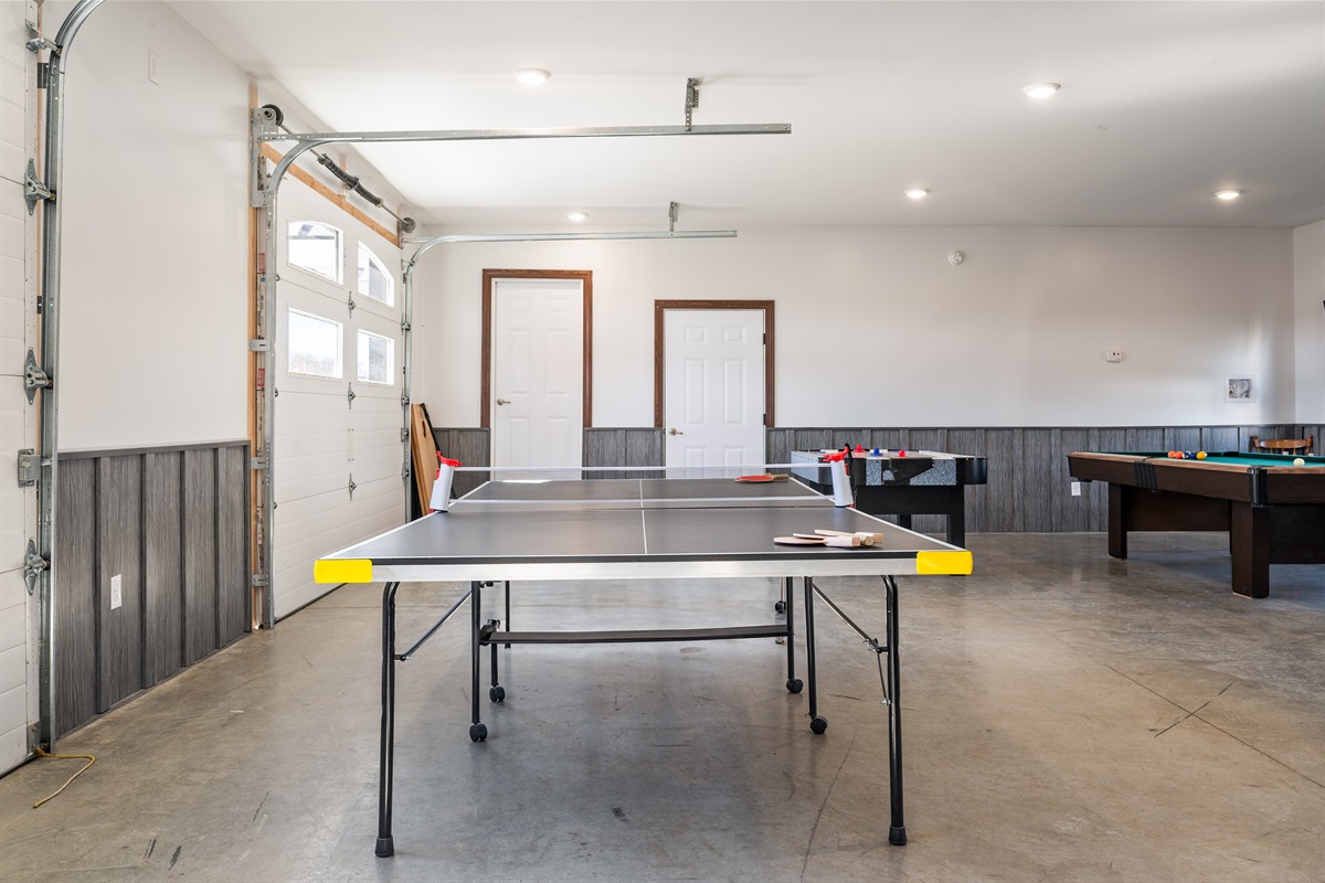 Open-concept loft with games and seating—ideal for groups to relax, play, and unwind after lake adventures!