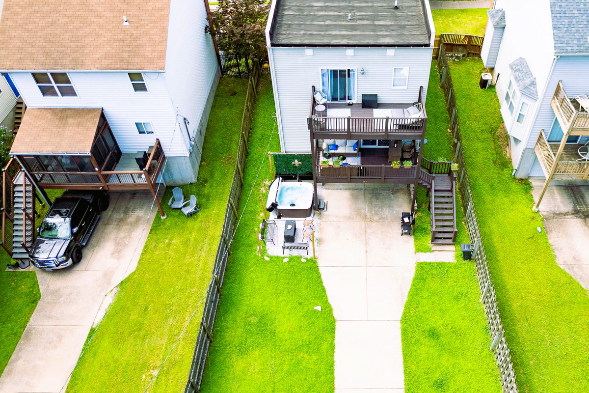 Private fenced backyard with hot tub, fire table, and gas grill. PLUS room for kids and dogs to play with secure gated parking — a major perk for a central St. Louis stay.
