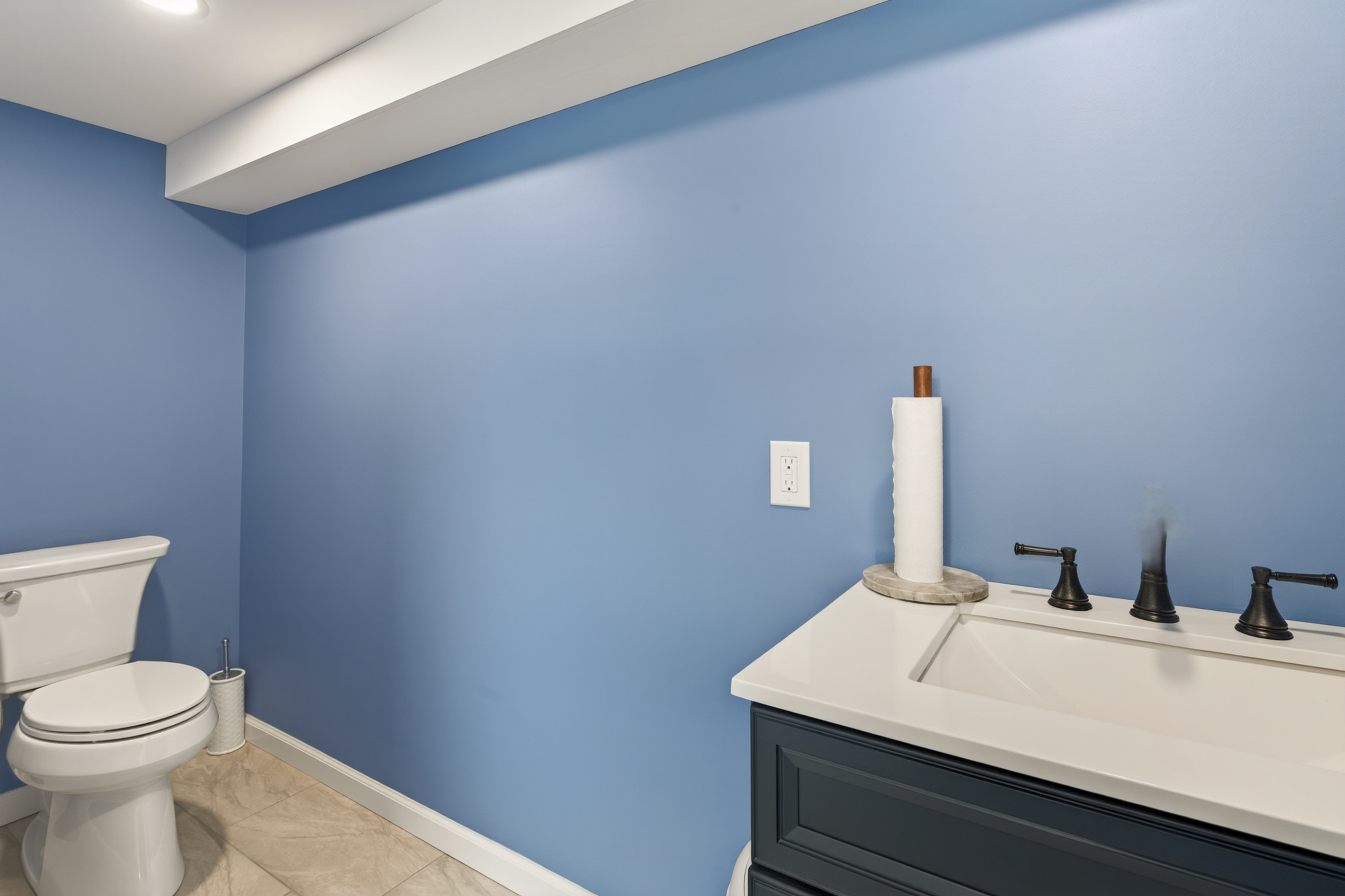 Half bathroom with blue walls