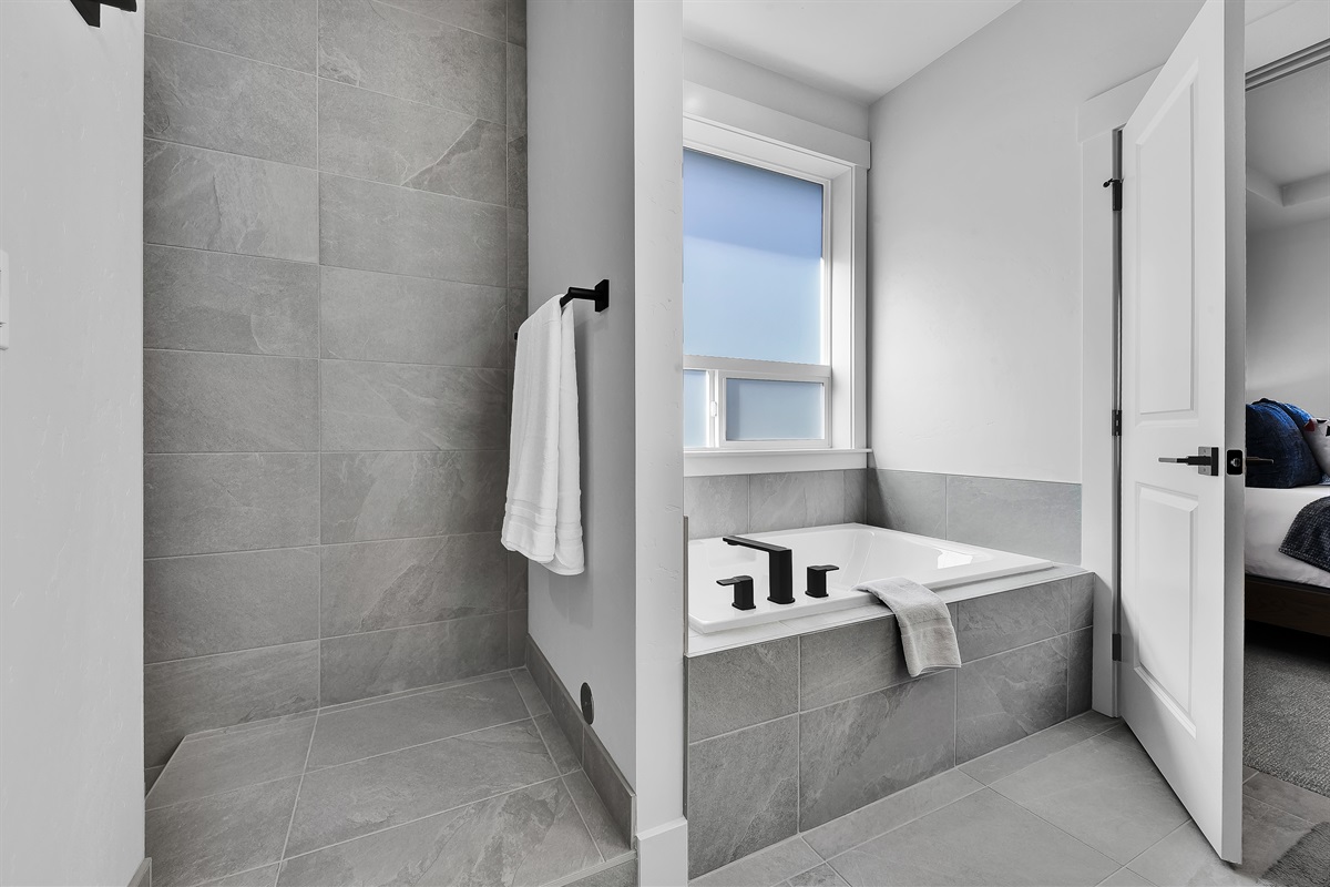 Primary bathroom shower and tub area