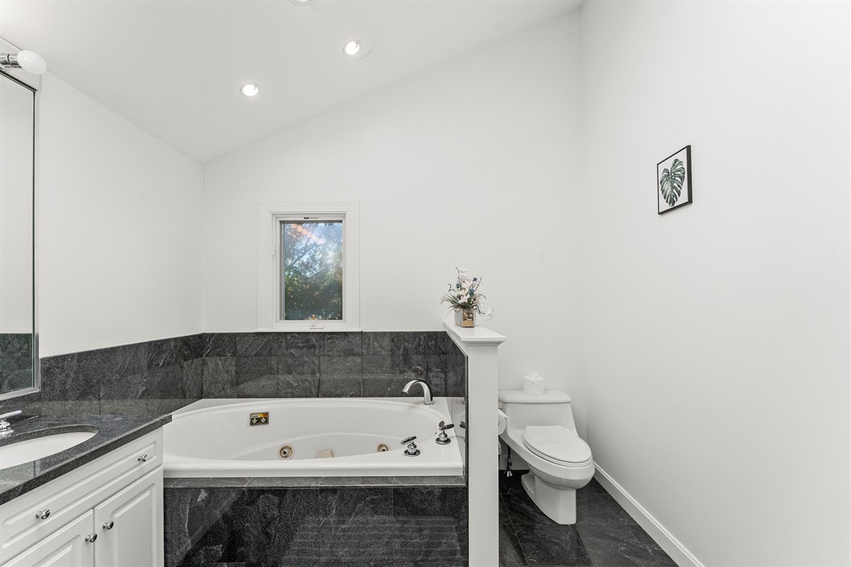 Relax in the queen ensuite featuring a jetted tub and standing shower.