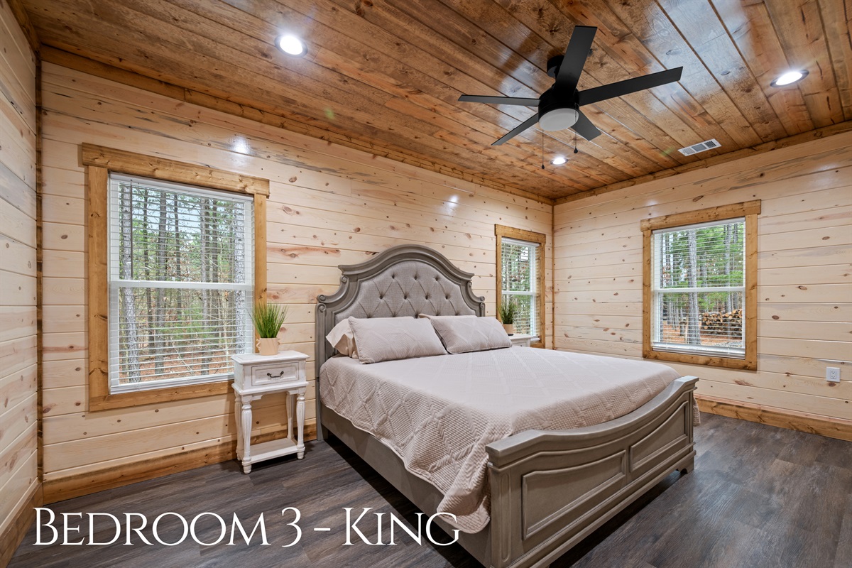 The third king bedroom offers another relaxing place to rest, featuring a plush bed, warm natural tones, and a calm environment perfect for winding down.